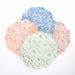 Ditsy Daisy Side Plates in assorted pastel pink, mint, blue, and mauve colors with white daisy prints and green leafy details on a white background.