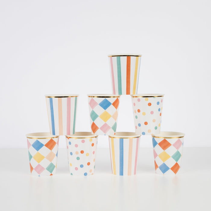 Colorful Pattern Cups arranged in a pyramid with assorted striped, polka dot, and checkered designs in bright multicolor shades with gold rims.