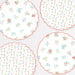 Ditsy Posy Scalloped Dinner Plates with white background, tiny multicolor floral prints, green leaves, and red scalloped edges.