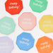 Mixed Happy Birthday Side Plates in assorted bright colors with white Happy Birthday lettering and octagon shapes.
