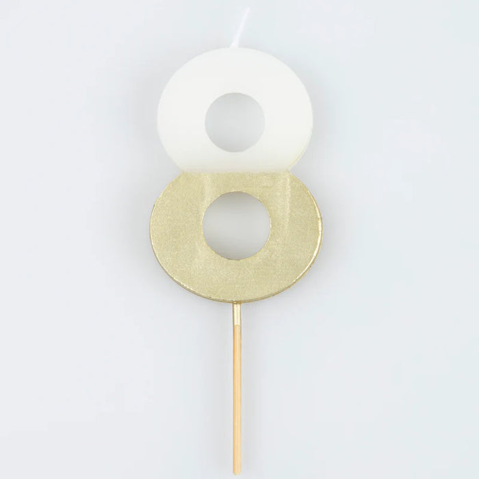 White number 8 cake candle with metallic gold dipped finish and wooden pick on a white background.