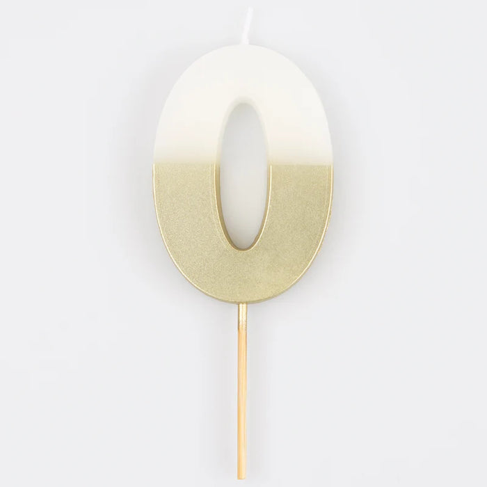 White number 0 cake candle with metallic gold dipped finish and wooden pick on a white background.