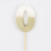 White number 0 cake candle with metallic gold dipped finish and wooden pick on a white background.