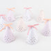 Broderie Anglaise party hats in pastel colors with scalloped edges, floral cutouts, and ribbon bows.