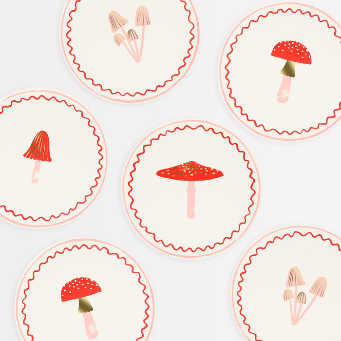 Merry Mushrooms Side Plates with assorted mushroom illustrations, red wavy borders, and soft pink accents.
