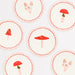 Merry Mushrooms Side Plates with assorted mushroom illustrations, red wavy borders, and soft pink accents.
