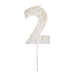 White number 2 cake candle with gold speckle accents and white pick on a white background.