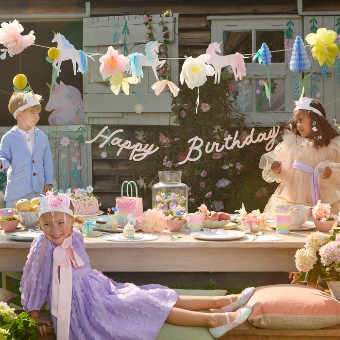 Meadow Unicorns Garland with pastel unicorns, paper flowers, honeycomb accents, greenery, and a coordinating Happy Birthday banner.
