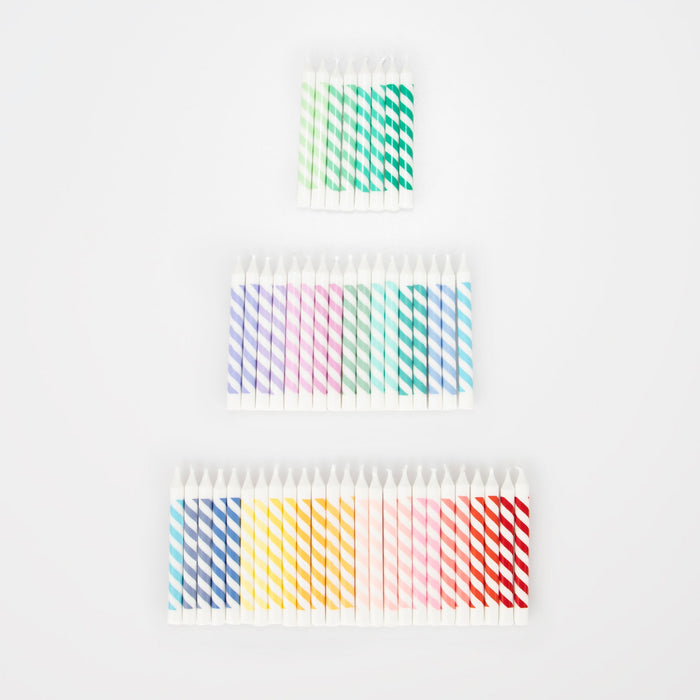 Rainbow Striped Mini Candles arranged in a tiered cake shape with 50 mini white birthday candles featuring colorful diagonal stripes.