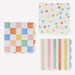 Colorful Pattern Small Napkins with checkerboard, polka dot, and stripe designs in pastel multicolor shades with scalloped edges on a white background.