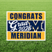 Meridian High School class of 2026 graduation yard sign with navy blue and gold striped design, large "M" logo, and white text on green grass background.