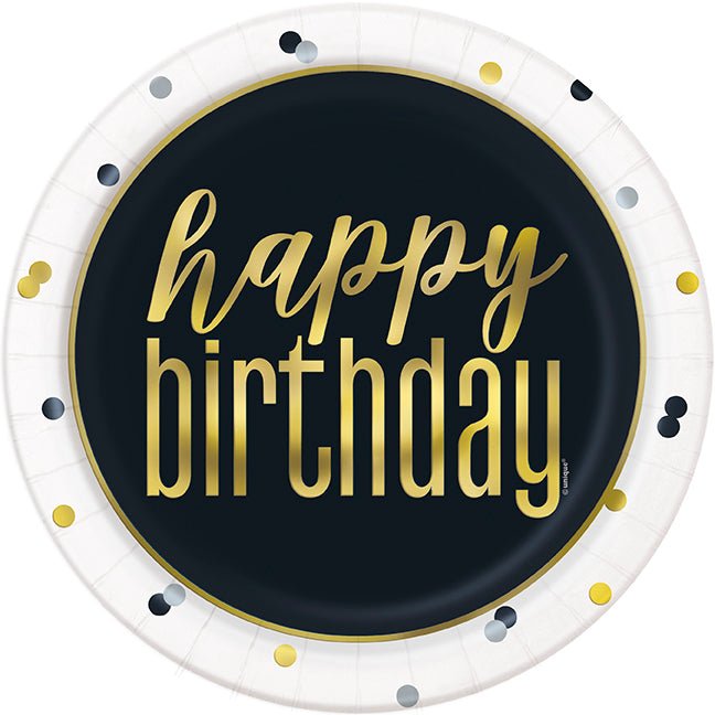 White paper plate with black center circle, gold "happy birthday" text, and gold and navy decorative dots around the border.