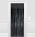 Black metallic fringe curtain with vertical streamers hanging in a white doorway frame against white walls with wainscoting.
