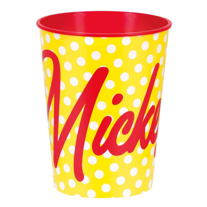 Yellow plastic cup with white polka dots, red interior rim, and large red cursive text reading "Minnie" on the front.