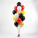 Balloon bouquet featuring black, red, yellow, gold, and white latex balloons with curling ribbons.