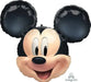 Black and flesh-toned Mickey Mouse head-shaped foil balloon with large round black ears, smiling face, and Anagram logo visible in corner.