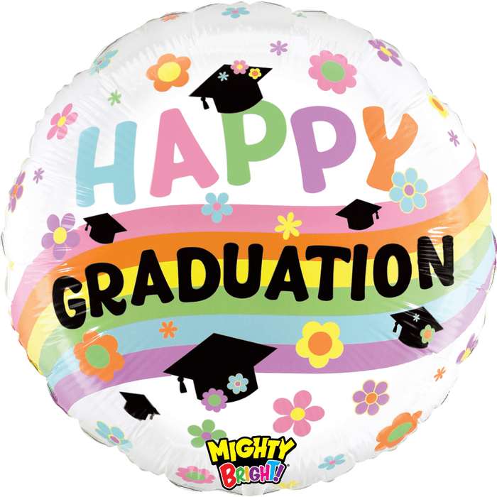 Round white mylar balloon with pastel rainbow bands, colorful flowers, black graduation caps, and "Happy Graduation" text in multicolored letters.