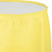 Bright yellow pleated table skirt with elastic band closure, shown laid flat against a white background.