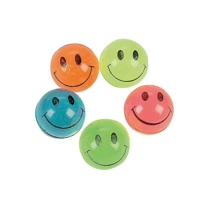 Five neon-colored rubber bouncy balls in orange, lime green, teal, coral pink, and lime green arranged in a circular pattern, each featuring a black smiley face with glittery eyes.