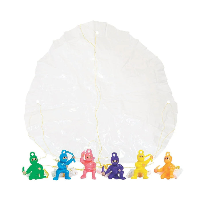 Six colorful mini ninja warrior figurines in green, blue, pink, purple, yellow, and orange with attached parachutes displayed in front of a large translucent white parachute.