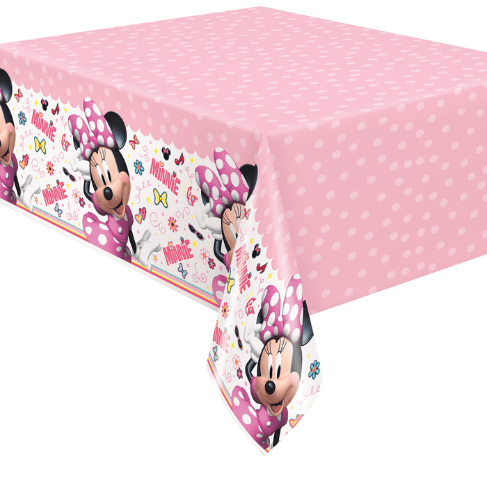 Pink polka dot plastic tablecloth featuring Minnie Mouse in purple polka dot dress with colorful floral designs and text scattered across white side panels.