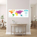 Colorful world map wall chart with rainbow-colored continents, "Called to Serve" text, and Matthew 28:19 Bible verse displayed above a light wood console table in a bright living room.