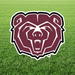 Maroon bear head logo with white outline on a green grass background, featuring a yard sign cutout with registered trademark symbol.