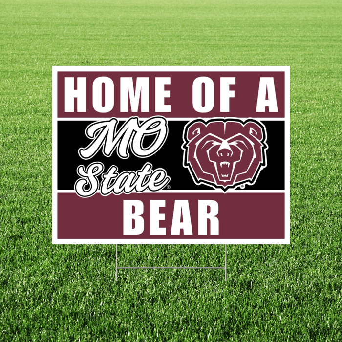 Maroon and white yard sign with bear logo reading "Home of a Mo State Bear" displayed on green grass.