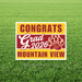 Yellow and maroon yard sign with white text reading "CONGRATS Grad 2026 MOUNTAIN VIEW" and a gold paw print logo on green grass.
