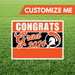 Graduation-themed customizable sign with 'Congrats Grad 2026' on a grass background