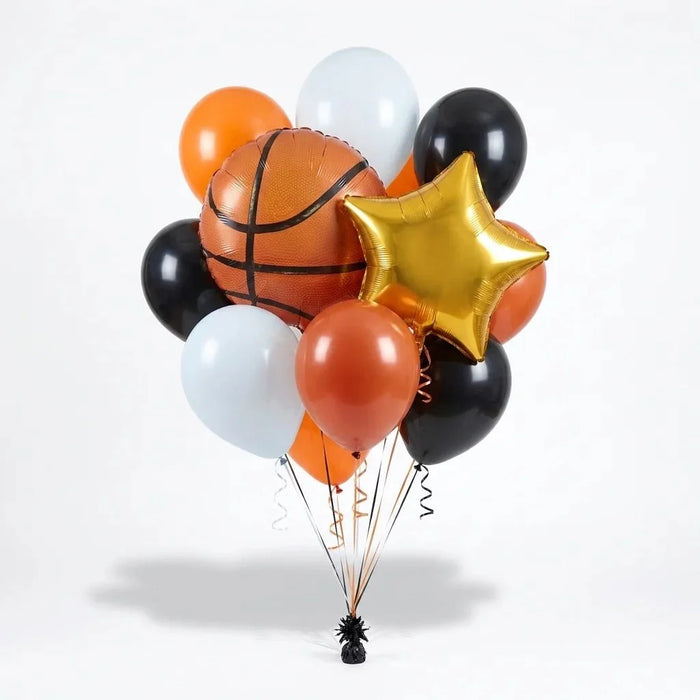 Basketball-themed balloon bouquet featuring a large basketball foil balloon, a gold star-shaped foil balloon, and black, orange, and white latex balloons with curling ribbons.