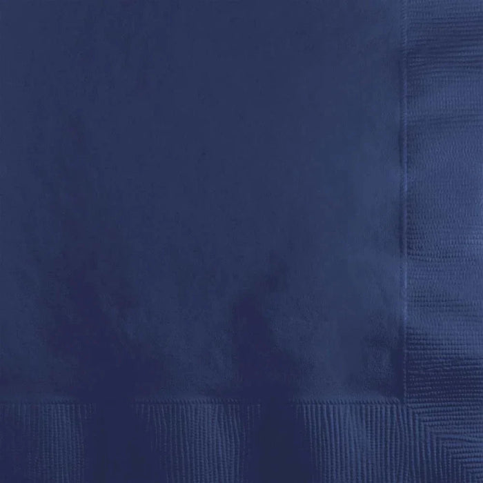 Stack of navy blue beverage napkins showing folded edges and textured material in various shades of blue.