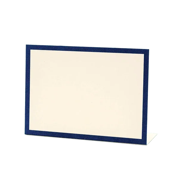 Navy blue fabric-bordered place card with cream-colored interior panel, displayed at an angle to show its three-dimensional standing form.