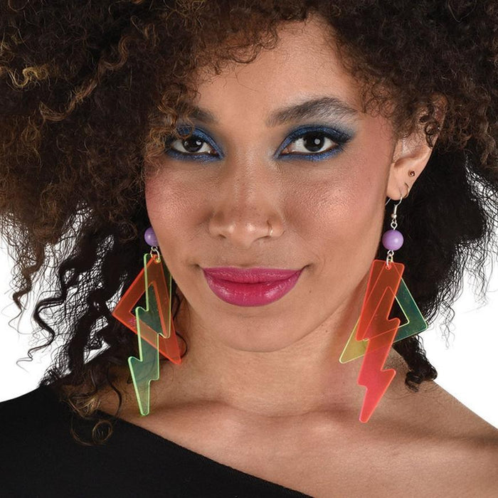 Pair of neon lightning bolt earrings in red and green with purple bead accents, displayed on a model wearing blue eyeshadow and pink lipstick.