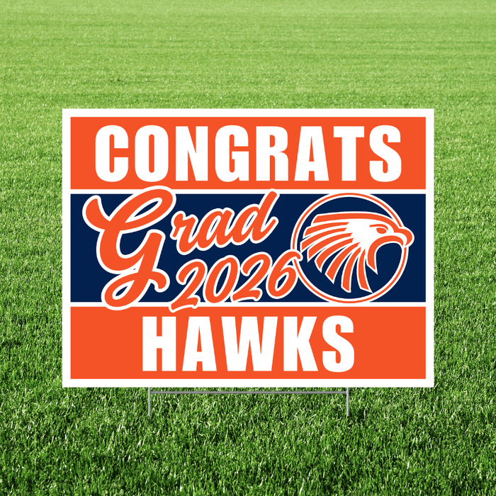 Graduation-themed sign with 'Congrats Grad 2026 Hawks' on a grass background