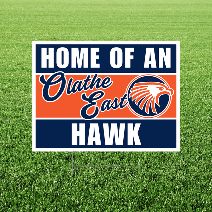 Sign with 'Home of an Olathe East Hawk' text and logo on a grass background