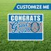 Graduation-themed customizable sign with 'Congrats Grad 2026' text on a grass background