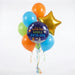 Space-themed birthday balloon bouquet with a dark blue round foil balloon reading "have an OUTTA THIS WORLD birthday" surrounded by five latex balloons in blue, green, and orange, a gold star balloon, and colorful ribbons.