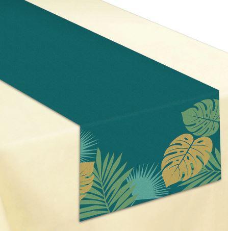 Teal table runner with gold and blue tropical palm leaf and monstera leaf designs displayed diagonally on a cream background.