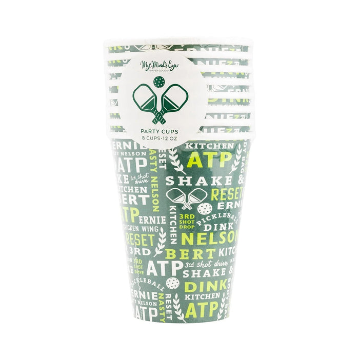 Eight 12-ounce paper party cups with green and yellow pickleball-themed designs, featuring crossed paddle graphics and repeated text about kitchen, shake, and pickleball motifs.