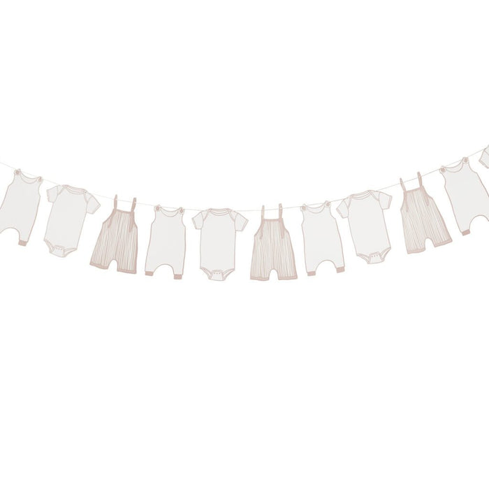Beige and pink baby clothing items hanging on a clothesline string, including onesies, bodysuits, overalls, and rompers with decorative clothespins.