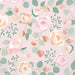 Pink napkin with floral pattern featuring peach roses, pink blooms, green foliage, and gold circular accents on a light pink background.