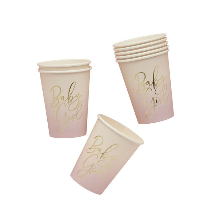 Three pink ombre paper cups with "Baby Girl" printed in gold script text, shown in different angles against a white background.