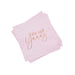 Stack of pink napkins with small red hearts scattered throughout and rose gold text reading "she said Yaaas" printed on the front.