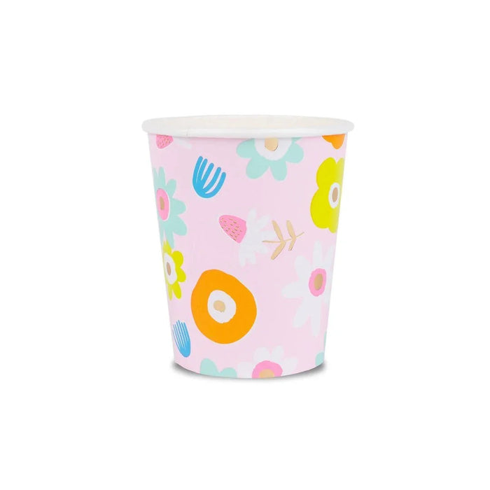Pink disposable cup with colorful floral and geometric patterns including yellow, orange, and mint green flowers with white centers on a light pink background.