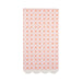 Pink napkin with repeating orange floral and geometric pattern design and white scalloped edges along the bottom.