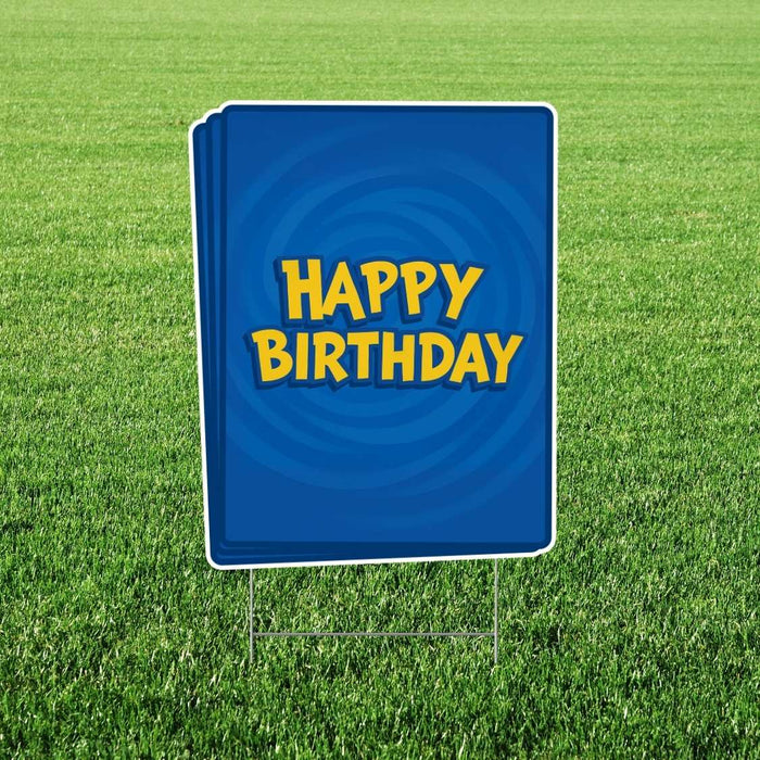 Blue yard sign with yellow "HAPPY BIRTHDAY" text and a swirl design, mounted on metal stakes in grass.