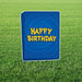 Blue yard sign with yellow "HAPPY BIRTHDAY" text and a swirl design, mounted on metal stakes in grass.