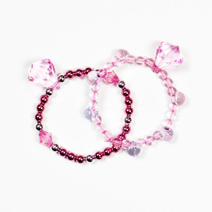 Two pink beaded bracelets with faceted crystal charms and dark red metallic spacer beads, displayed on a white background.