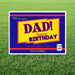 Rectangular yard sign with blue and red borders featuring a yellow banner with bold text reading "DAD! Happy BIRTHDAY" and decorative script reading "We love you" and "America's Premium Father," displayed on green grass.